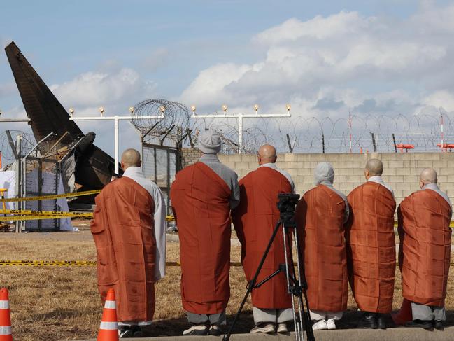 Buddhist monks from the Jogye sect's Social and Labour Committee mourn for the victims of the Jeju Air Boeing 737-800 series aircraft that crashed and burst into flames. Picture: AFP