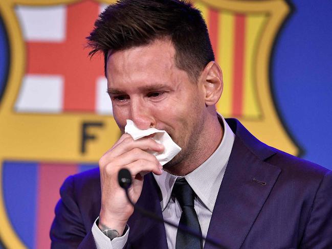 Barcelona's Argentinian forward Lionel Messi cries at the start of a press conference at the Camp Nou stadium in Barcelona on August 8, 2021. - The six-time Ballon d'Or winner Messi had been expected to sign a new five-year deal with Barcelona on August 5 but instead, after 788 games, the club announced he is leaving at the age of 34. (Photo by Pau BARRENA / AFP)