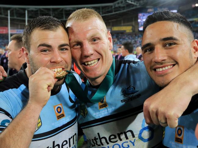 Wade Graham takes a bite of Luke Lewis's Clive Churchill Medal with Valentine Holmes  during the Cronulla Sharks v Melbourne Storm NRL Grand Final at ANZ Stadium, Sydney Olympic Park, pic Mark Evans