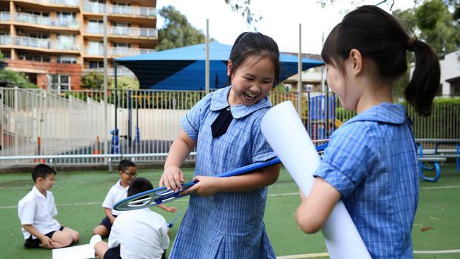 Students Annie and Shirley Chen enjoy an outdoor maths class at Sydney Adventist School in Auburn in the city’s west. Picture: Jane Dempster