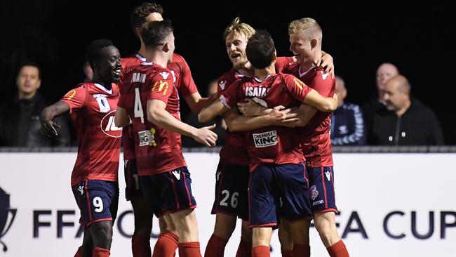 Adelaide United players celebrate Jordan Elsey’s goal. Picture: AAP