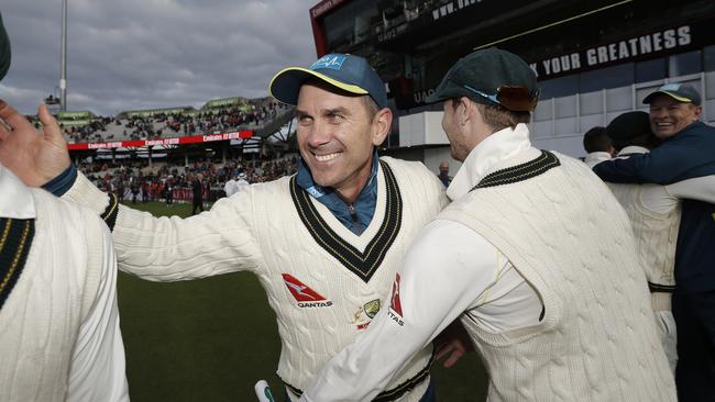 Justin Langer, coach of Australia, celebrates with Steve Smith at Old Trafford.