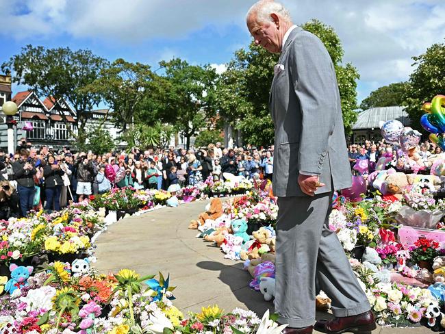 King Charles looked at the many tributes left for victims of the senseless attack. Picture: AFP