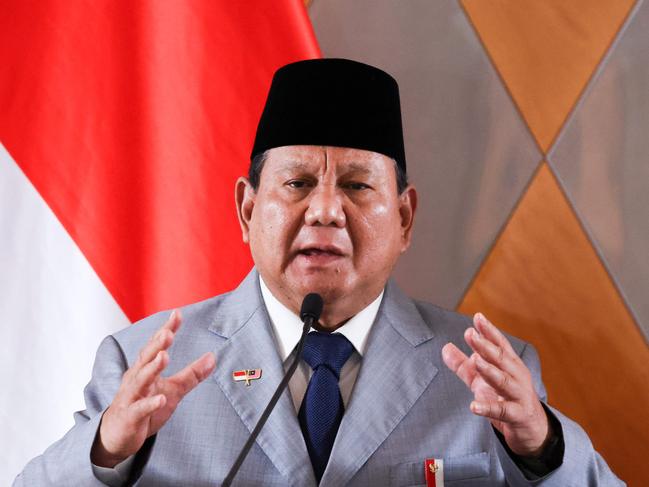 (FILES) Indonesia's President Prabowo Subianto speaks as he attends a press conference with Malaysian Prime Minister Anwar Ibrahim (not pictured) during a meeting in Kuala Lumpuron January 27, 2025. Wearing a traditional Indonesian black hat and shirt, President Prabowo Subianto speaks to the camera in an Instagram video, asking his people how he can help them after his election last year. But while the Indonesian leader's mouth moves and his eyes blink, the words he utters are part of a fraudulent deepfake scam uncovered by police this month that has swindled Indonesians across 20 provinces. (Photo by HASNOOR HUSSAIN / POOL / AFP)