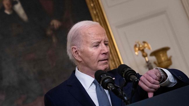 US President Joe Biden checks his watch as he arrives to provide an update from the Middle East.