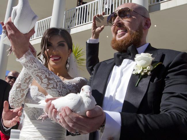 Kat and Ibraham Sakalakiat release white doves after the service. Picture: Jenny Evans
