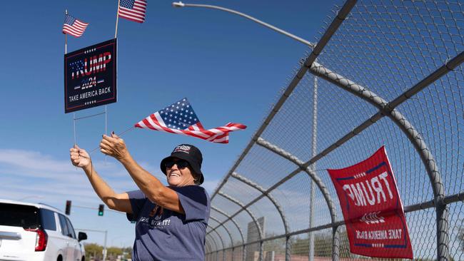 Becky Hager of Mesa, holds up a Trump campaign sign on a highway over pass on Election Day in Mesa, Arizona. Picture: Rebecca NOBLE / AFP