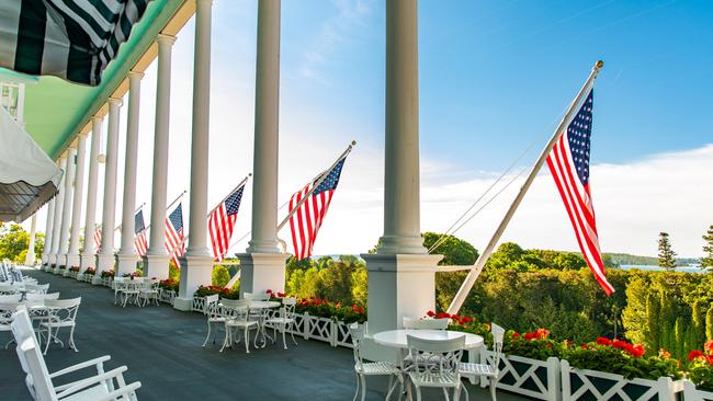 On the 201m front porch, I gaze out to the Straits of Mackinac, before descending the steps where Richard and Elise embrace. Picture: Grand Hotel.