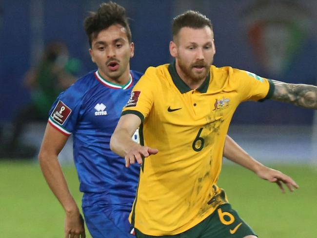 Australia's midfielder Martin Boyle (R) is marked by Kuwait's midfielder Mobarak al-Faneeni during the 2022 FIFA World Cup qualification group B football match between Australia and Kuwait at the Jaber Al-Ahmad Stadium in Kuwait City on June 3, 2021. (Photo by Yasser Al-Zayyat / AFP)