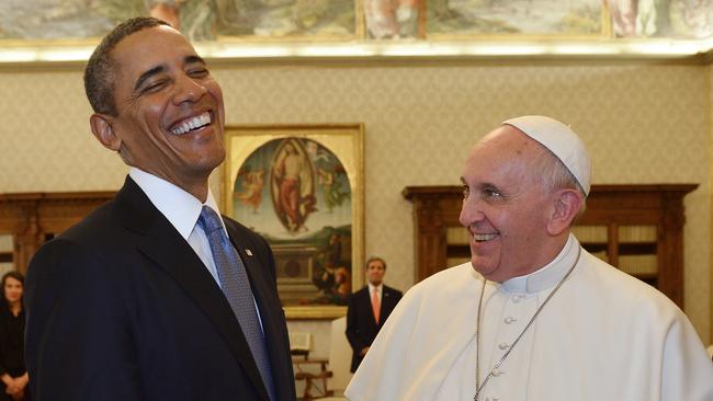 All smiles. Pope Francis and President Obama exchange gifts during a private audience in 2014. Picture: Gabriel Bouys/AFP