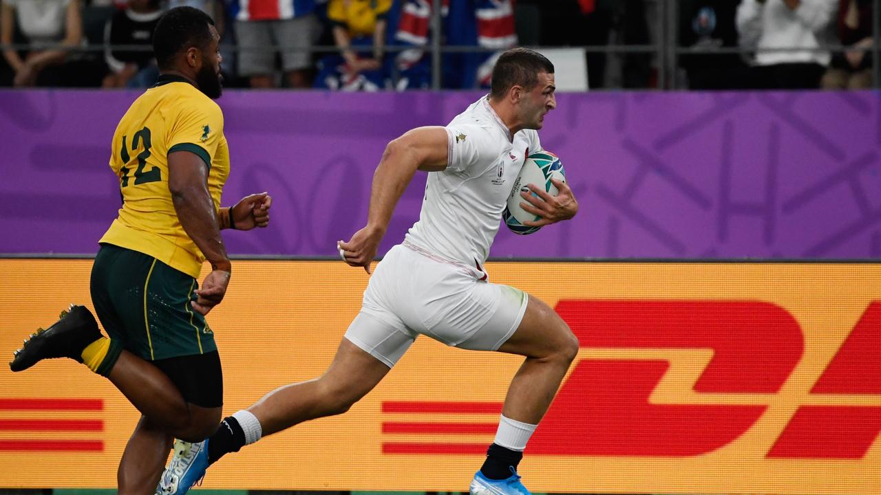 England’s Jonny May runs past Australia’s Samu Kerevi to score a try.