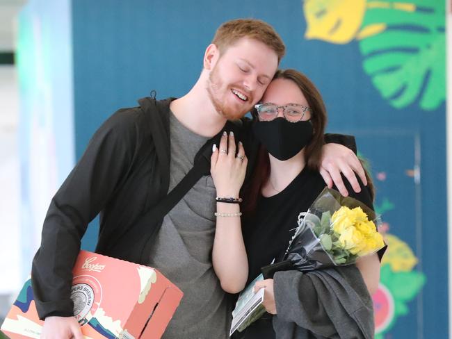 Airport Arrivals From Melbourne.First flight from Melbourne since the borders have opened on the 1st December 2020.Ash McCall with his girlfriend Harriet Beard after not seeing each other for 9 months.   Pic Tait Schmaal.