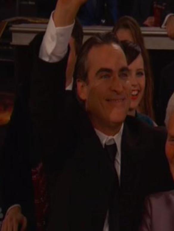 Joaquin Phoenix, enthusiastic waver.