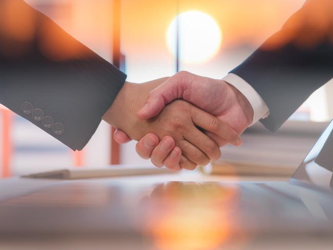 Businessmen handshaking with partner greeting dealing for business, finance and investment background, teamwork and successful business  joint venture concept with sunrise background; merger deal generic