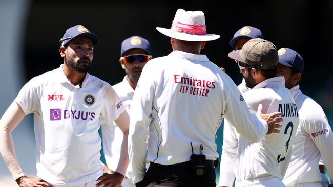 Indian paceman Mohammed Siraj and teammates speak to umpire Paul Reiffel about the incident. Picture: Getty Images