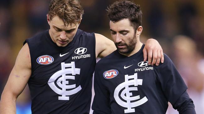 Patrick Cripps and Kade Simpson walk off after another huge loss. Picture: Michael Klein