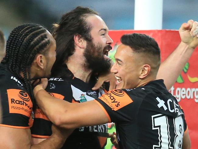 Aaron Woods of the Tigers celebrates his first try of the season during the St George Illawarra Dragons v Wests Tigers round 26 NRL game at ANZ Stadium, Sydney Olympic Park. pic Mark Evans