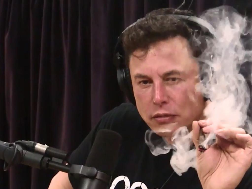 Tesla CEO Elon Musk smoking marijuana during an interview with comedian Joe Rogan. Automotive heads around the world have come under increasing pressure. Picture: THE JOE ROGAN EXPERIENCE