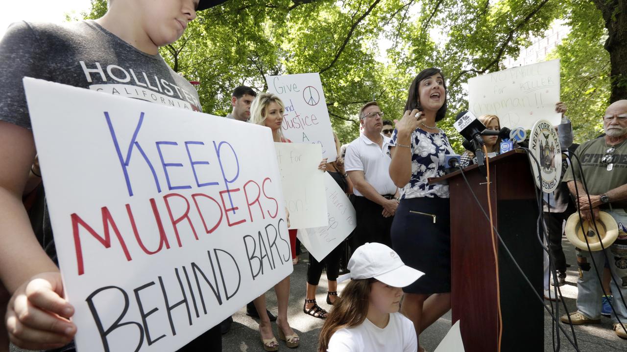 Beatles fans joined Nicole Malliotakis at the Strawberry Fields Memorial, with signs. Picture: AP Photo/Richard Drew.