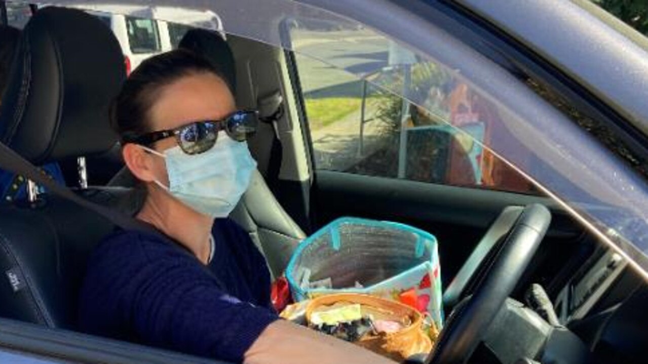 Elisabeth Freudigmann of Indooroopilly in her car after having a coronavirus test today. Picture: Brendan O’Malley