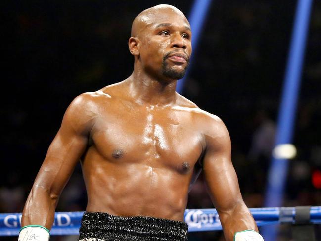 (FILES) In this file photo taken on September 12, 2014 Floyd Mayweather Jr. looks on while taking on Marcos Maidana during their WBC/WBA welterweight title fight at the MGM Grand Garden Arena in Las Vegas, Nevada. - Floyd Mayweather, who retired from boxing in 2017 with a perfect 50-0 record, said April 10, 2020 he hopes emulate late uncle Roger by becoming a successful trainer. (Photo by AL BELLO / GETTY IMAGES NORTH AMERICA / AFP)