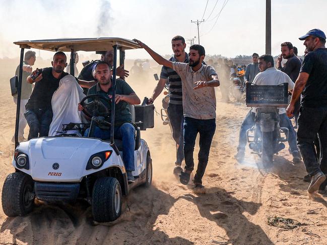 Palestinians transport a reportedly captured Israeli person, in Khan Yunis in the southern Gaza Strip. Picture: AFP