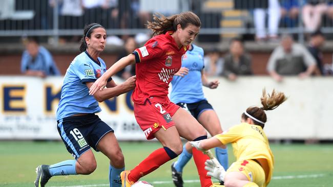 Leena Khamis (left) of Sydney competes for the ball with Cheyenne Hammond (centre) and Eliza Campbell of United during the round 4 W-League match between Sydney FC and Adelaide United at Seymour Shaw Park in Sydney on Sunday, Nov. 27, 2016. (AAP Image/Paul Miller)