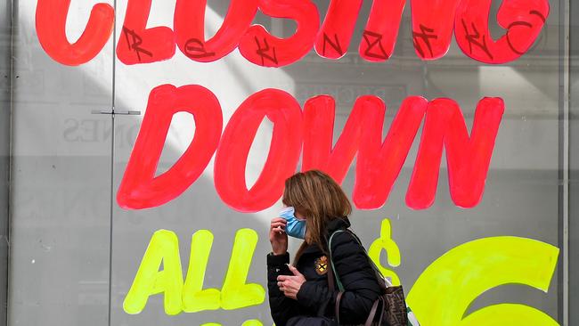 A woman walks past an empty shop in Melbourne’s central business district. PIcture: AFP