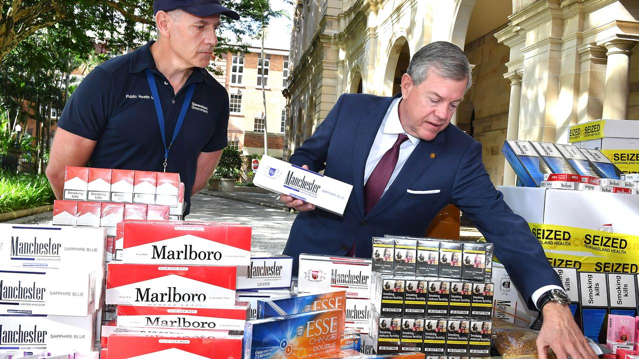 Health Minister Tim Nicholls with a public health officer and seized illegal tobacco. Picture: John Gass