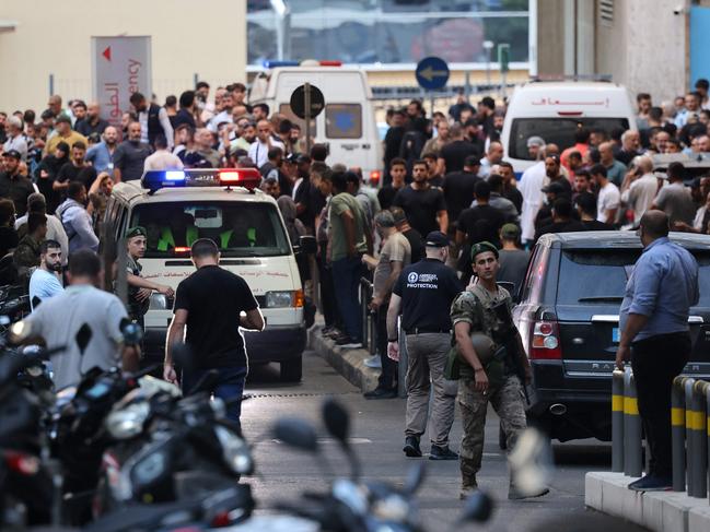 Ambulances are surrounded by people at the entrance of the American University of Beirut Medical Center. Picture: AFP