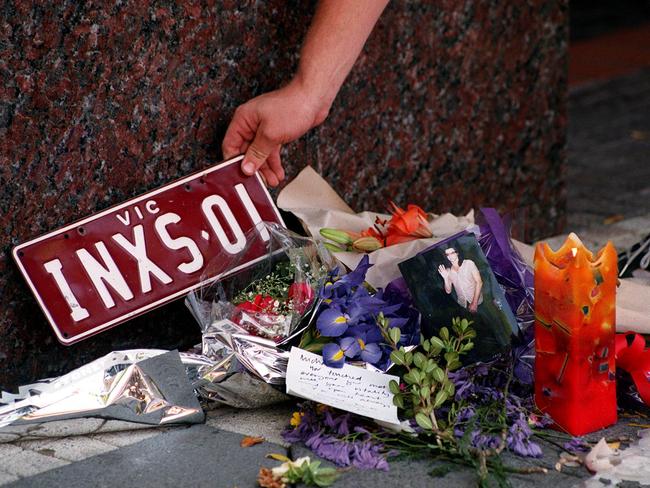 Flowers, candles and other items left in tribute outside the Ritz Carlton Hotel in Double Bay, Sydney, by fans of rock singer Michael Hutchence who was found dead in the hotel, in 1997. Picture: Nicole Emanuel