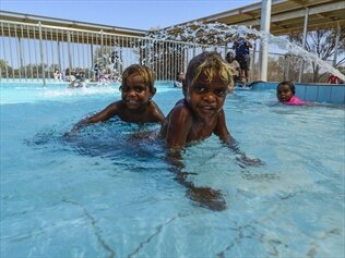 Children enjoy their new community swimming pool at Mutitjulu, Uluru