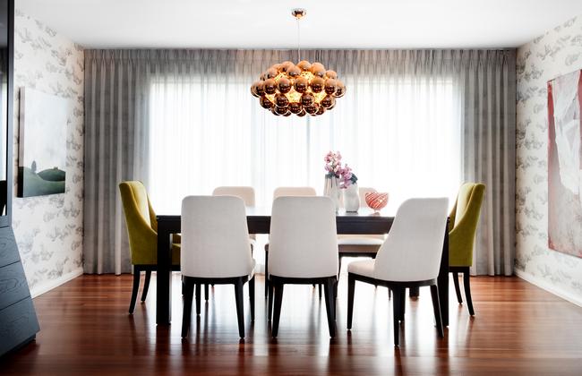 In this living room, Karen Akers used a neutral base then layered it with splashes of colours red, green, bronze and citrus. Picture: Thomas Dalhoff