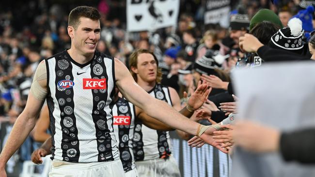 MELBOURNE, AUSTRALIA – MAY 21: Mason Cox of the Magpies high fives fans after winning the round 10 AFL match between Carlton Blues and Collingwood Magpies at Melbourne Cricket Ground, on May 21, 2023, in Melbourne, Australia. (Photo by Quinn Rooney/Getty Images)