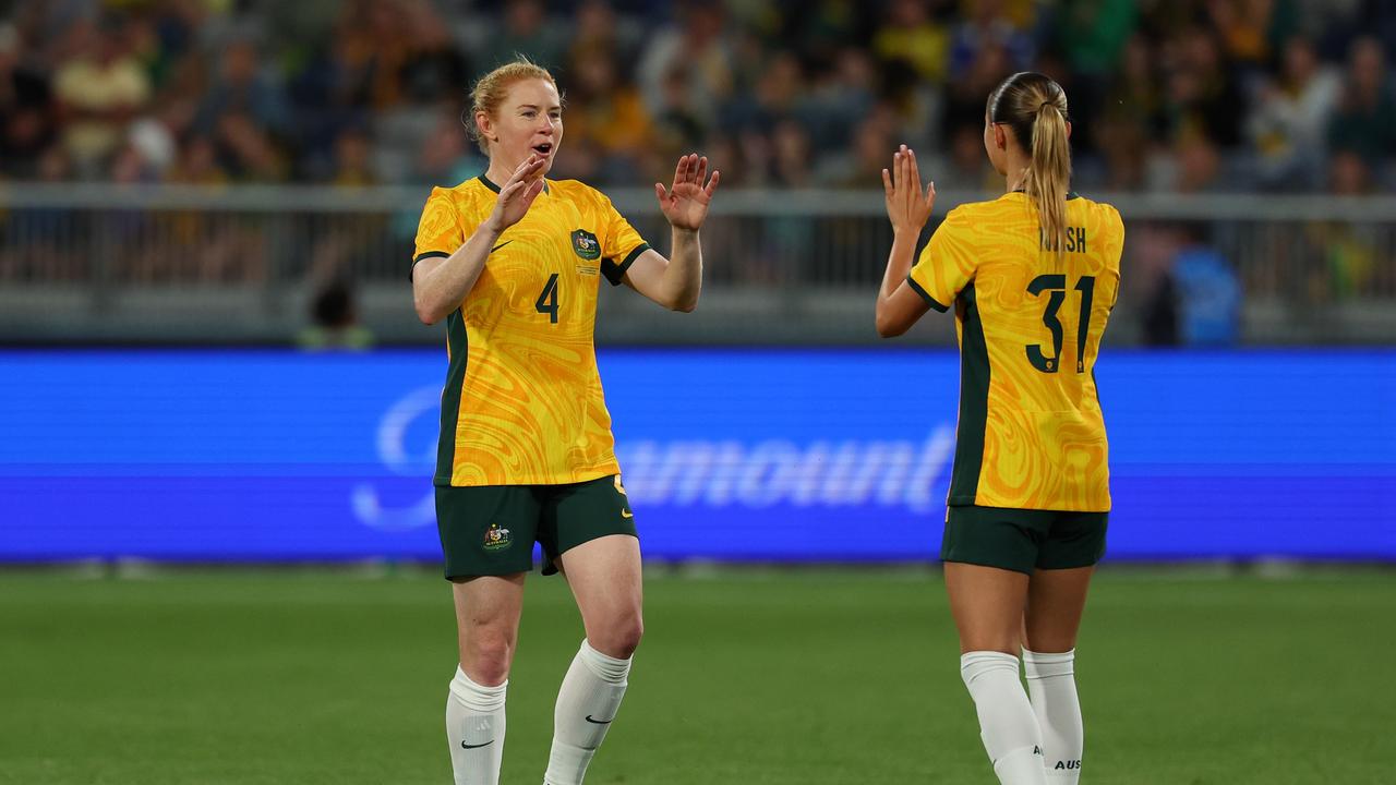 Clare Polkinghorne (left) leaves the field after her final appearance for the Matildas. Picture: Morgan Hancock/Getty Images