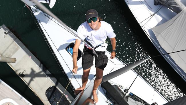 Tom Fountain up the mast of the Whisper at the Cruising Yacht Club. Whisper which is owned by David Griffith will be competing in the Sydney Hobart. Picture: John Feder / The Australian.