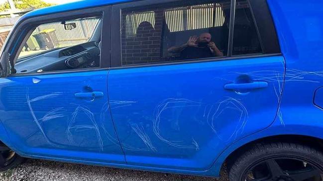 Bendigo man Rustyn Woodman, 45, was horrified to find his car smashed and flooded with a sprinkler about 2am on Monday with the homophobic slur “fa***t” written on the side.