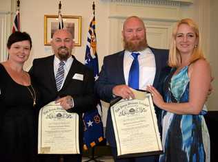 Bradley Morrison (second from left) and Steven Hird (third from left) received bravery awards for rescuing a baby from a burning car. They are pictured with their wives, Joanne Morrison (left) and Tenille Hird (right). Picture: Pamela Frost