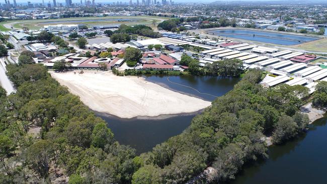 Workmen two thirds of the way towards filling Black Swan Lake at Bundall. Picture: Glenn Hampson