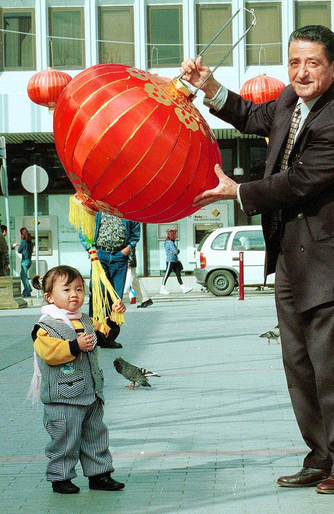 Former Fairfield Mayor Anwar Khoshaba with 20 month old Lusy Nguyen in Freedom Plaza Cabramatta for preparations for Moon Festival in 2002. Picture: Charlie Steell