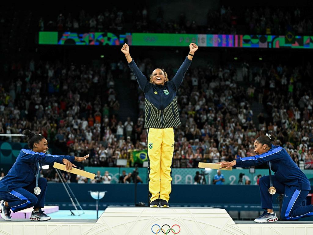 Simone Biles (silver), Brazil's Rebeca Andrade (gold) and Jordan Chiles (bronze) pose during the podium ceremony for the artistic gymnastics women's floor exercise event. (Photo by Gabriel BOUYS / AFP)