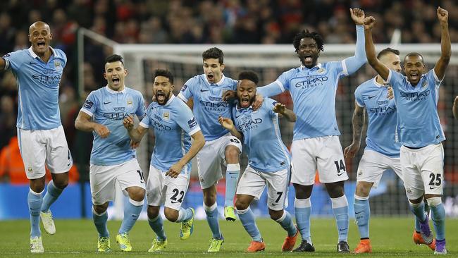 Manchester City players celebrate after winning the English League Cup final