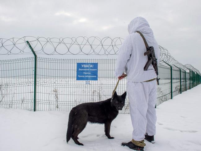 An Ukrainian frontier guard patrols along the border with Russia, some 40 km from the second largest Ukrainian city of Kharkiv. Picture: AFP