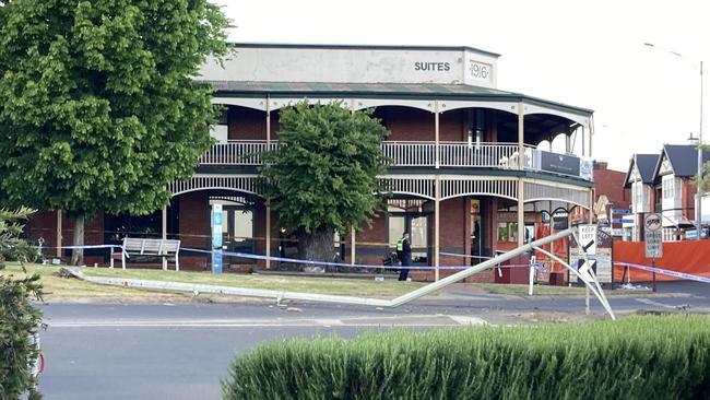 A crumpled light pole lays across the intersection outside, the Royal Hotel, where five people were killed on Sunday night.