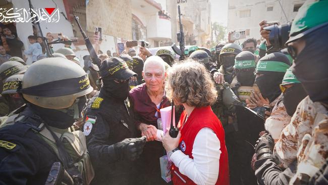 Gadi Moses is handed over to a Red Cross team in Khan Yunis. Picture: AFP.