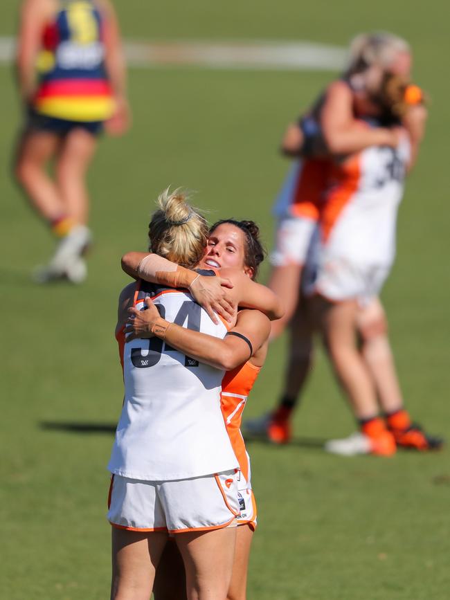 Jacinda Barclay embrace teammate Jessica Dal Pos after beating the Crows in March. Picture: Matt Turner/AFL Photos via Getty Images