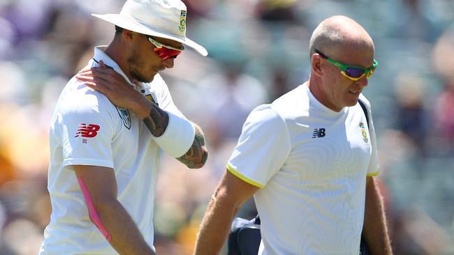 Dale Steyn of South Africa walks from the field with the team physio.