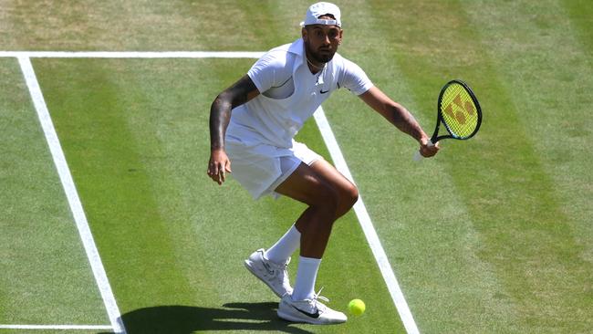 LONDON, ENGLAND - JULY 10: Nick Kyrgios of Australia plays a forehand with his left hand against Novak Djokovic of Serbia during their Men's Singles Final match on day fourteen of The Championships Wimbledon 2022 at All England Lawn Tennis and Croquet Club on July 10, 2022 in London, England. (Photo by Shaun Botterill/Getty Images)