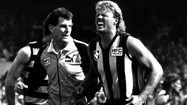 Dermott Brereton is helped from the field during the 1989 Grand Final.