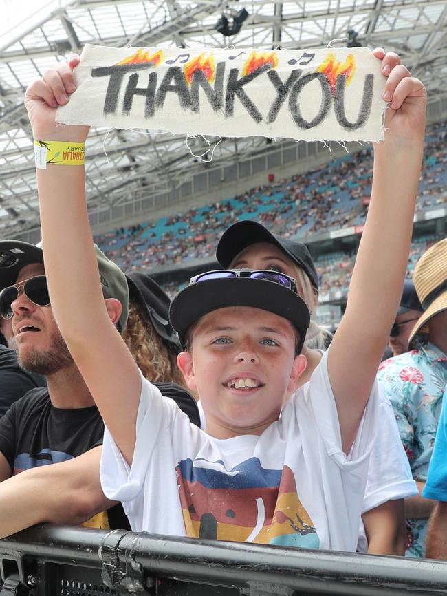 A grateful front-row fan at the Fire Fight Australia concert. Picture: Richard Dobson